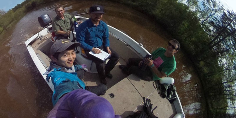 Shon Schooler and team of student researchers on a boat in St. Louis River Estuary