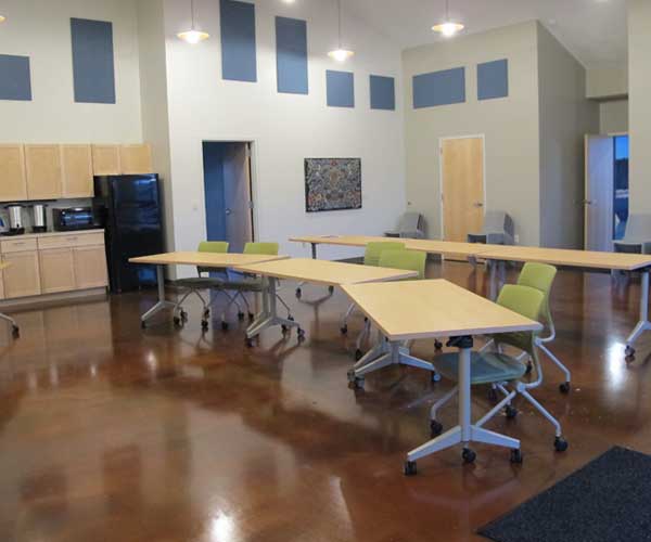 Confluence Room with tables, chairs and kitchenette